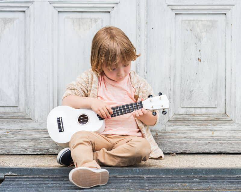 Fun Musical Instruments To Use In A Kindergarten child playing ukulele