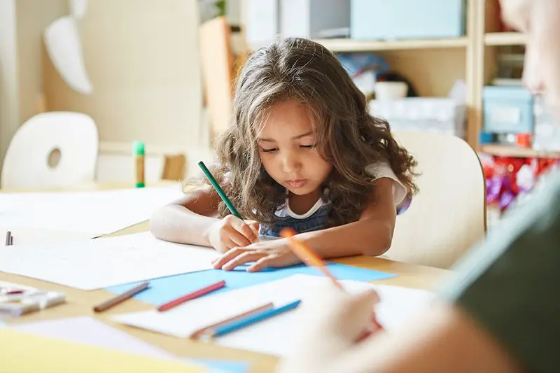 a young girl studying on her own