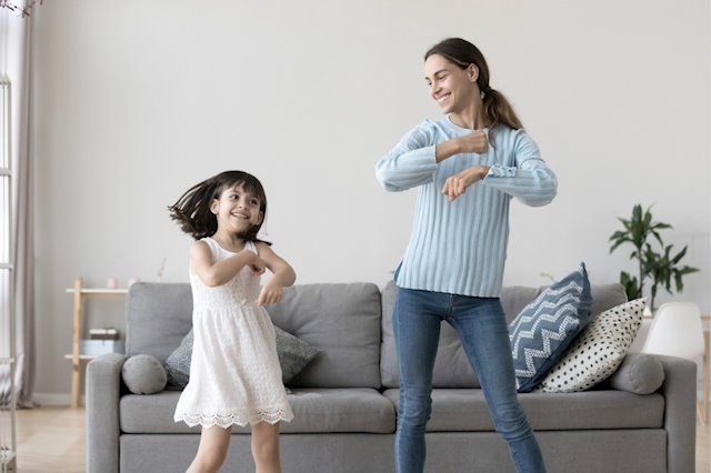 a mother dancing with her daughter