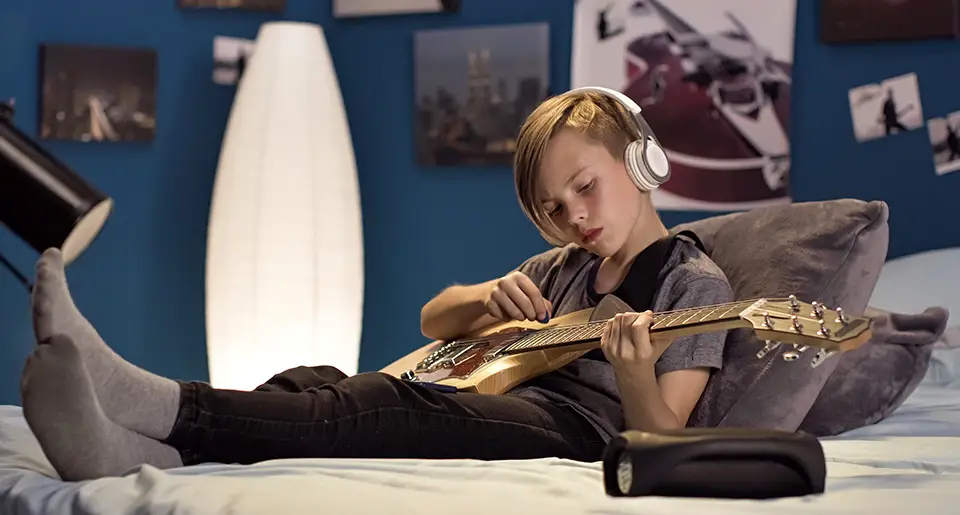 A boy playing a guitar