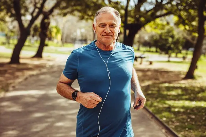 Older man jogging with headphones on