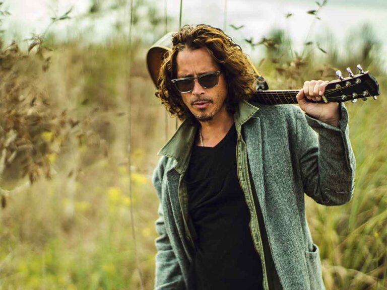 Chris Cornell carrying guitar