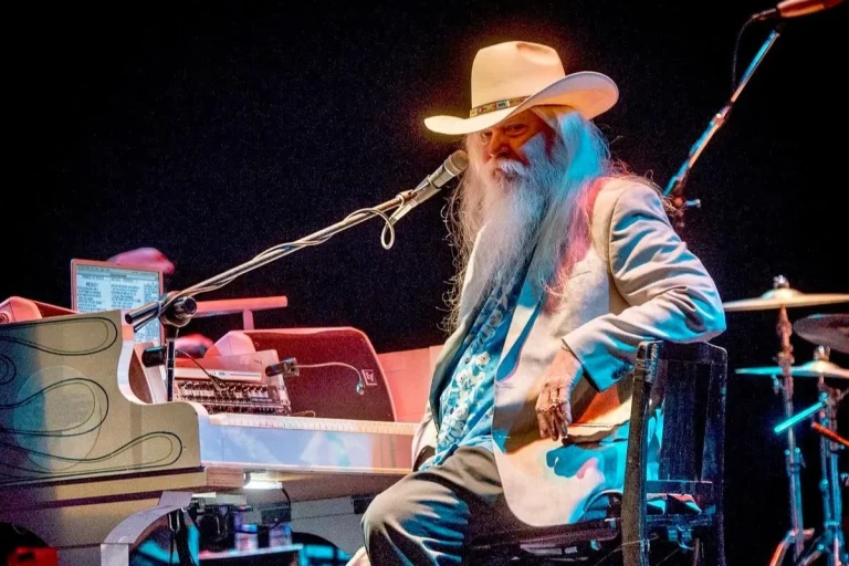 Leon Russell sat next to a piano