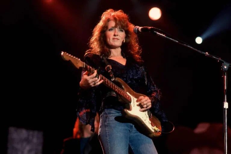 Bonnie Raitt on stage with a guitar