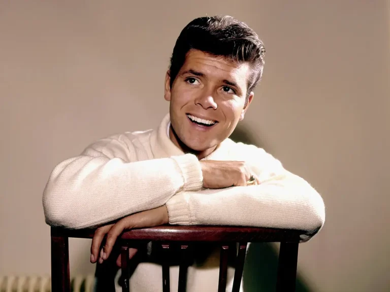 Cliff Richard posing on a chair