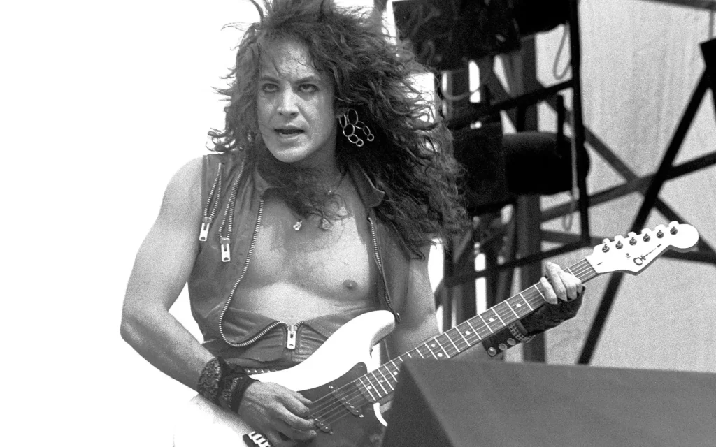 A young Jake E Lewis playing guitar