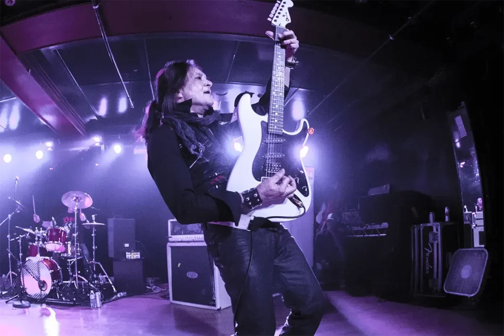 Jake E Lewis playing guitar