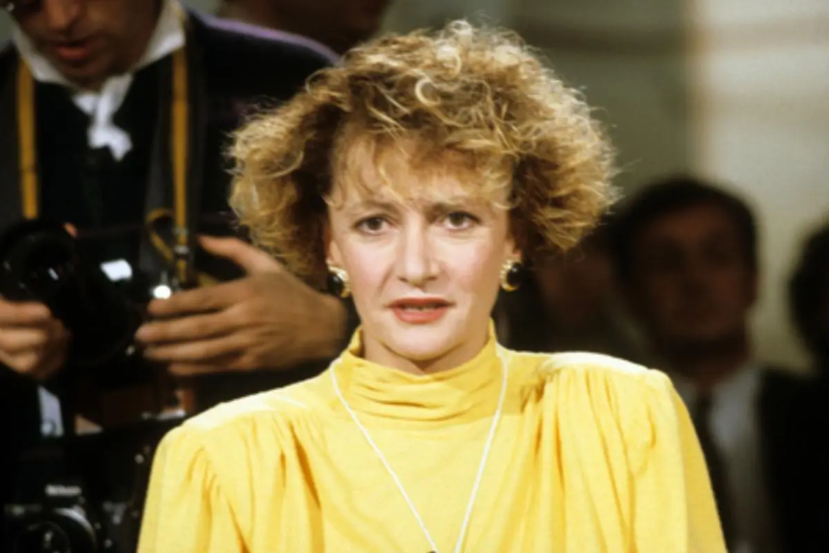 Annie D’Angelo seated at an event wearing a yellow dress.
