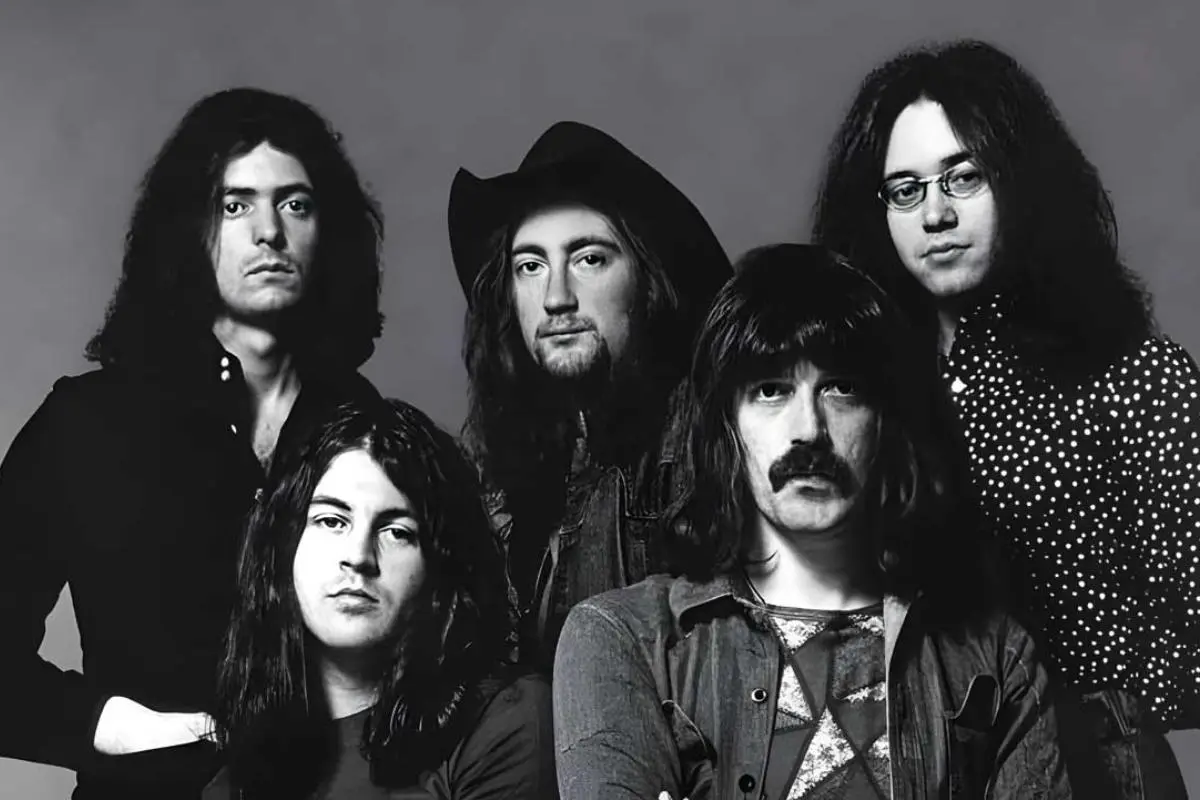 Deep Purple band portrait in black and white, featuring multiple members standing closely together.