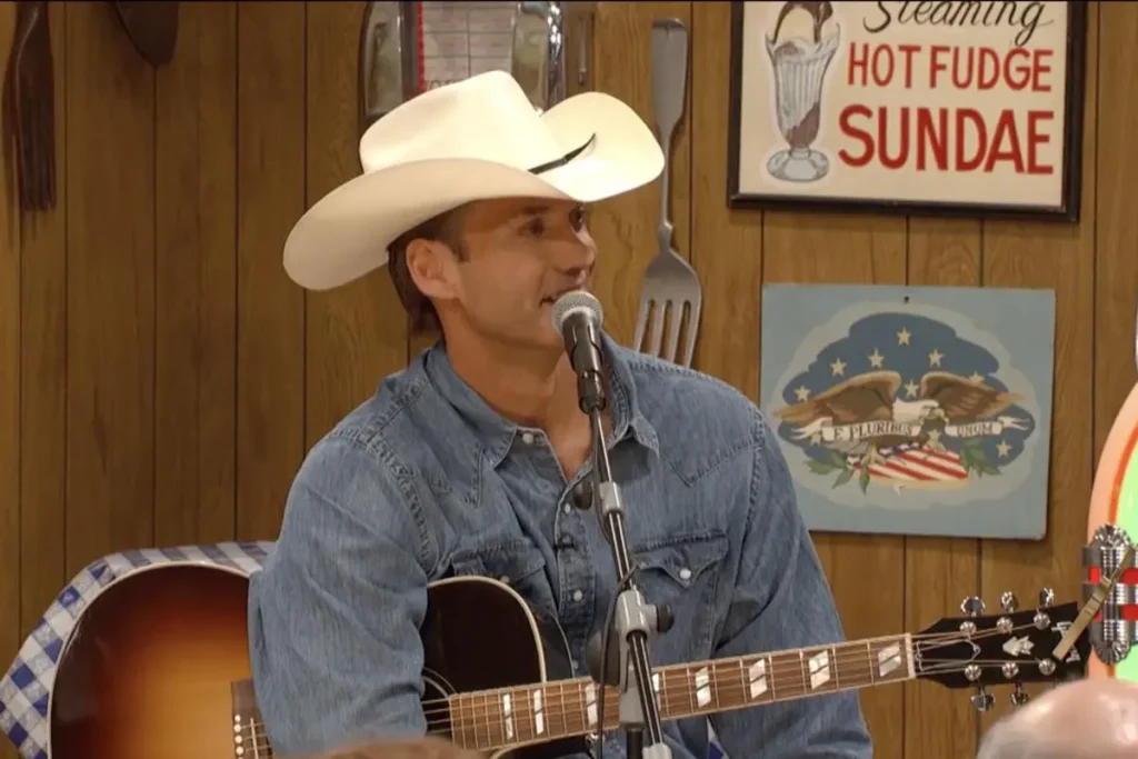 Ernest Tubb: The Texas Troubadour Who Turned Heartbreak Into Honky-Tonk Ernest Tubb wearing a white cowboy hat and denim shirt.