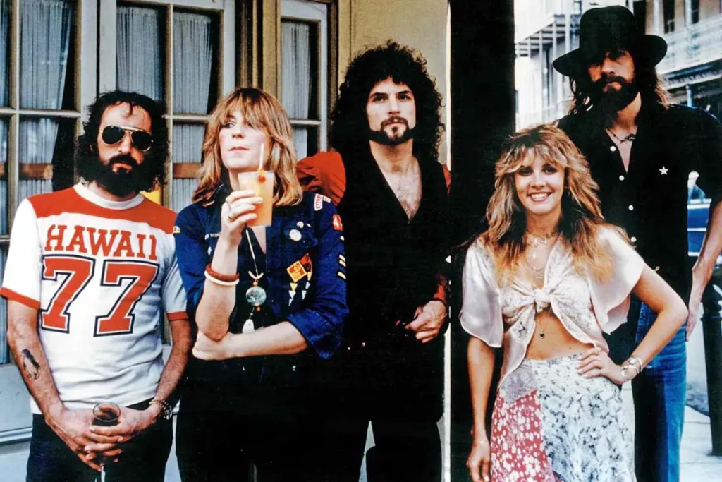Fleetwood Mac band members posing together outside a building.