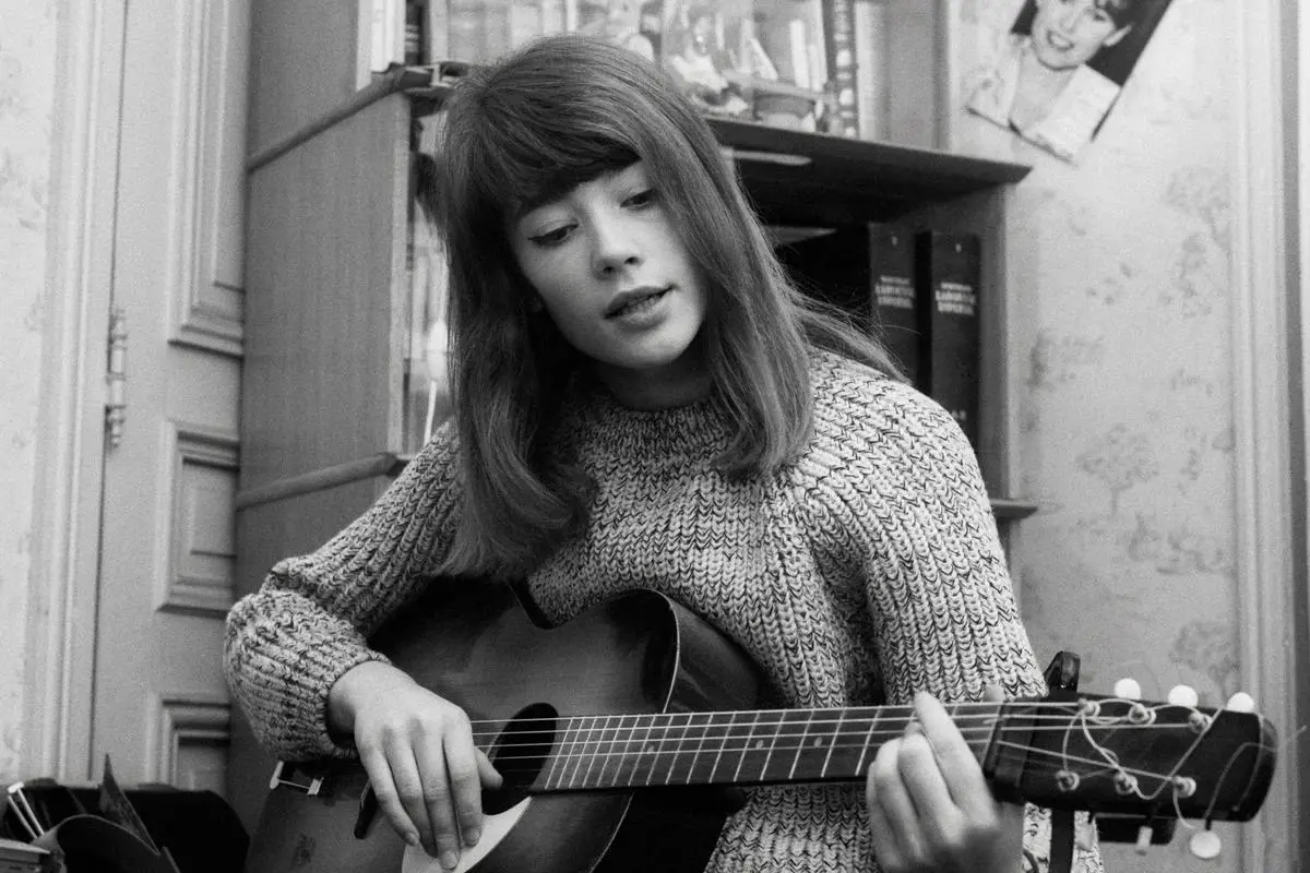 Françoise Hardy seated indoors.