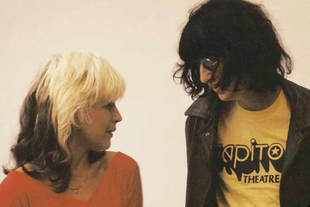 Joey Ramone, Debbie Harry, Johnny Ramone: The Crush That Split Punk’s First Family Joey Ramone and Debbie Harry facing each other in conversation, conveying camaraderie and the shared creative energy of the punk rock scene.