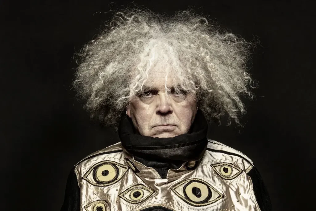 King Buzzo on Soundgarden’s Badmotorfinger: The “Grunge” Album That Outsmarted Grunge Studio portrait of King Buzzo with dramatic lighting and distinctive hair, wearing a patterned jacket that emphasizes an experimental and avant-garde aesthetic.