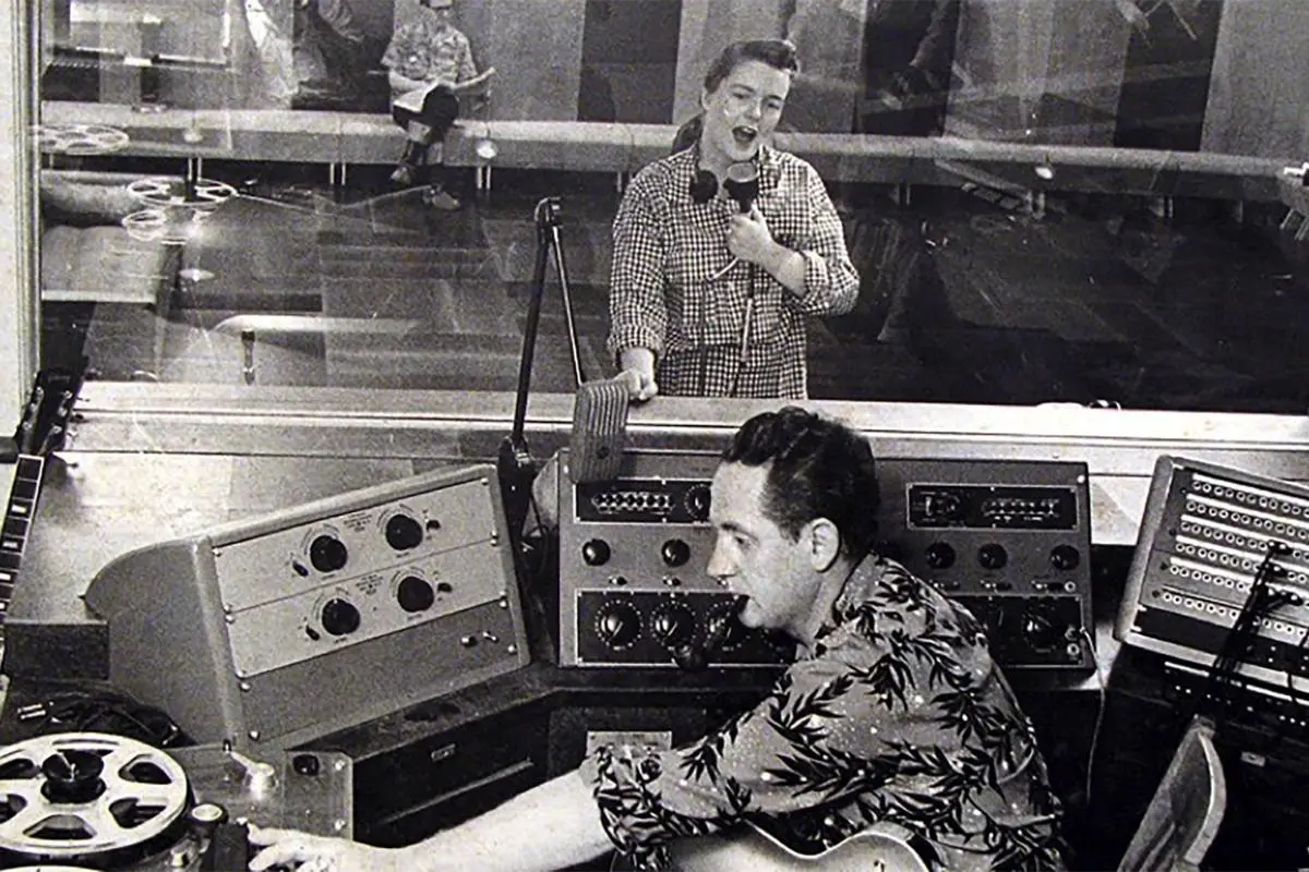 Les Paul operates a studio mixing console.
