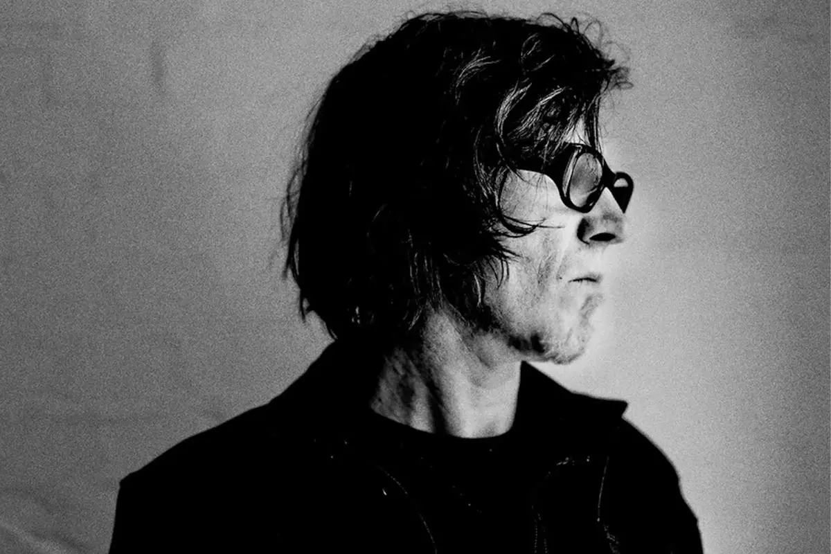 Mark Lanegan in profile, wearing dark sunglasses and looking off-camera.