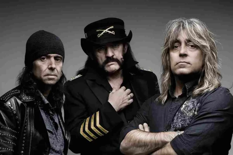 Motörhead posing in a studio portrait, wearing dark clothing with arms crossed.