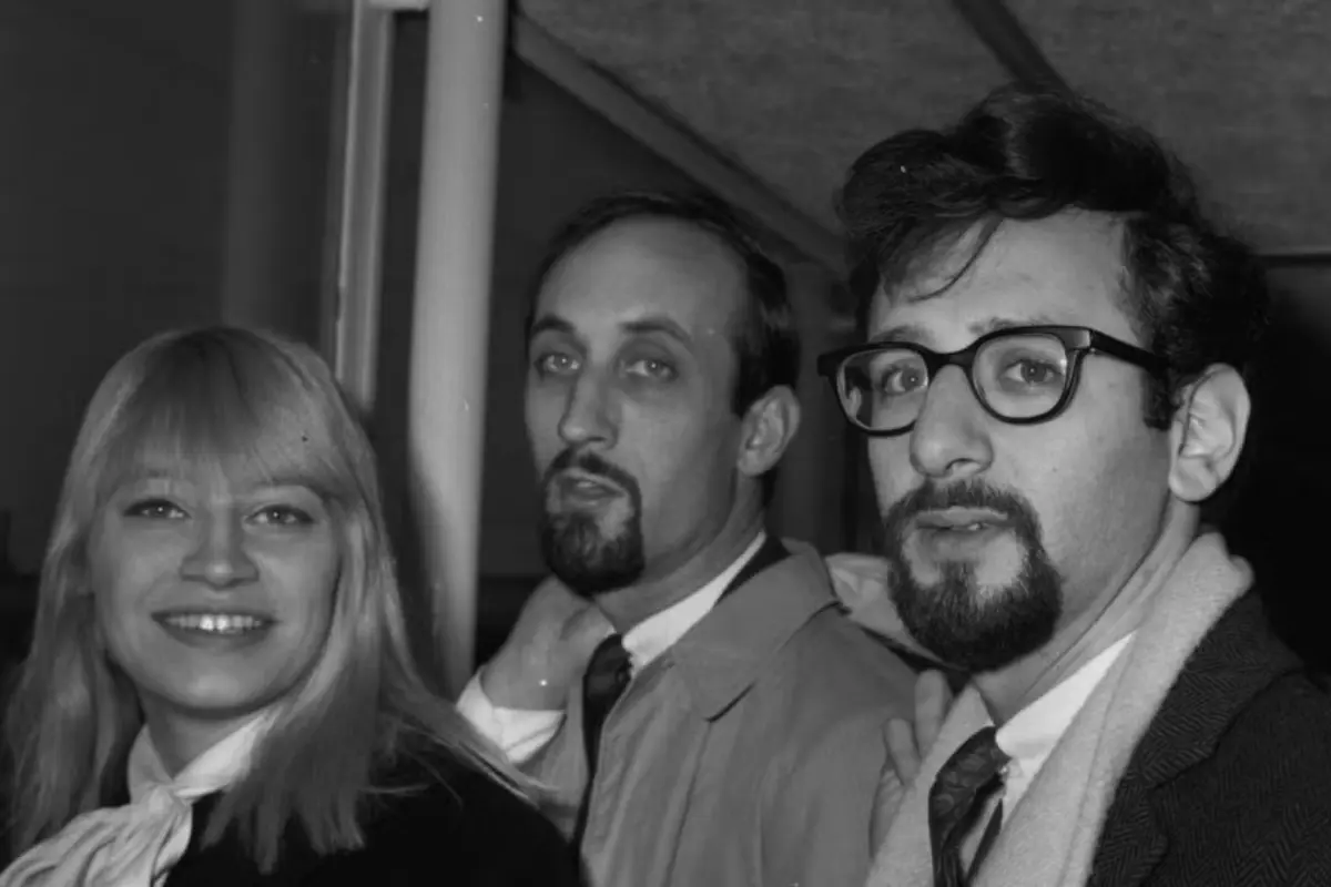 Peter, Paul and Mary standing close together, reflecting camaraderie and the informal spirit of the 1960s folk scene.