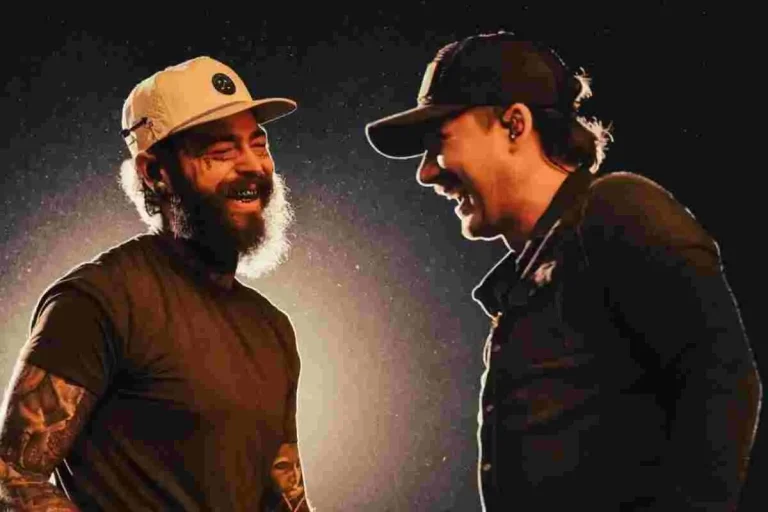 Post Malone and Morgan Wallen laughing together backstage, facing each other in casual hats and dark clothing.