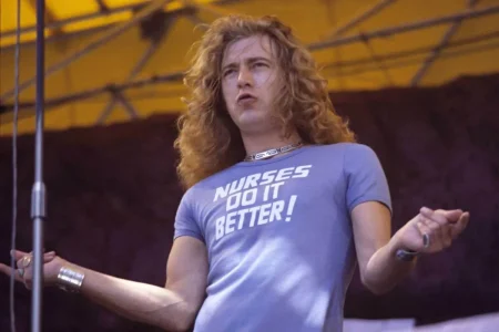 Robert Plant with long curly blond hair onstage.