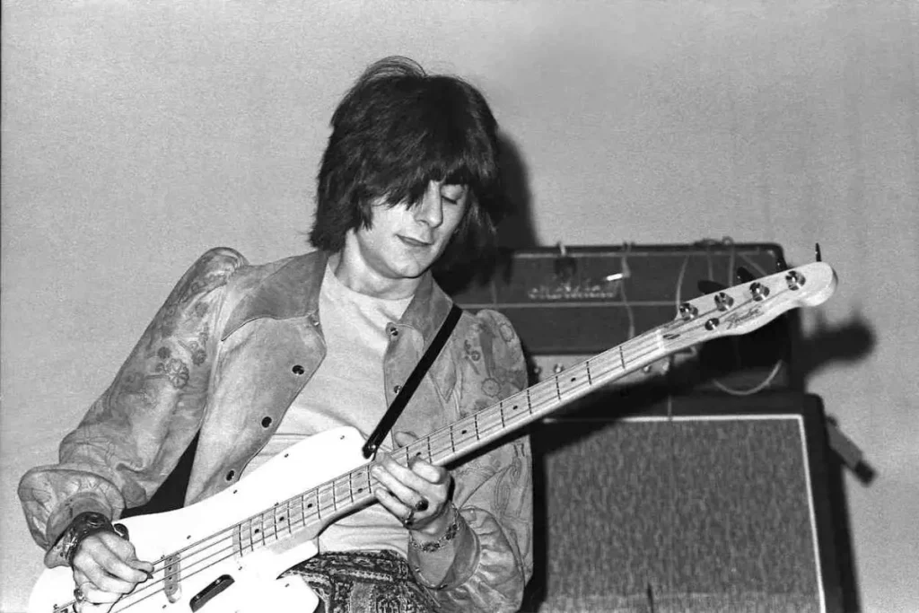Black-and-white photo of Ronnie Wood playing electric guitar onstage.