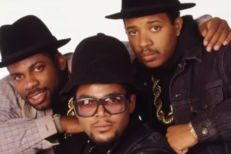 Run-DMC pose closely together for a studio portrait.