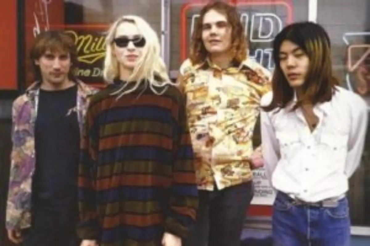 Early Smashing Pumpkins lineup standing outside a storefront in casual 1990s attire.