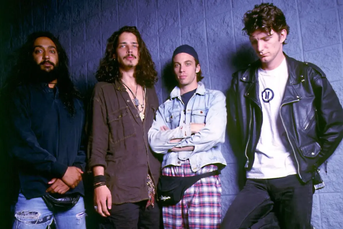 Badmotorfinger band standing against a textured wall, reflecting early-1990s alternative rock style and group identity.
