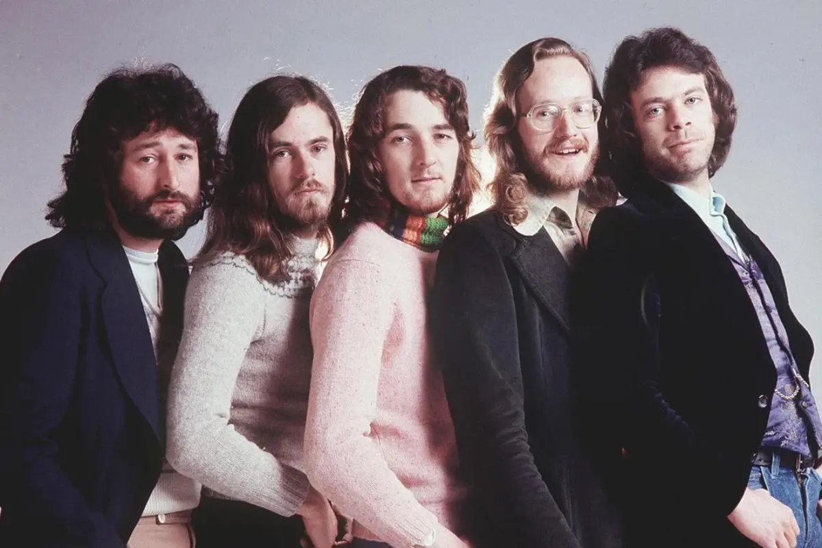 Studio portrait of Supertramp band members standing in a row.