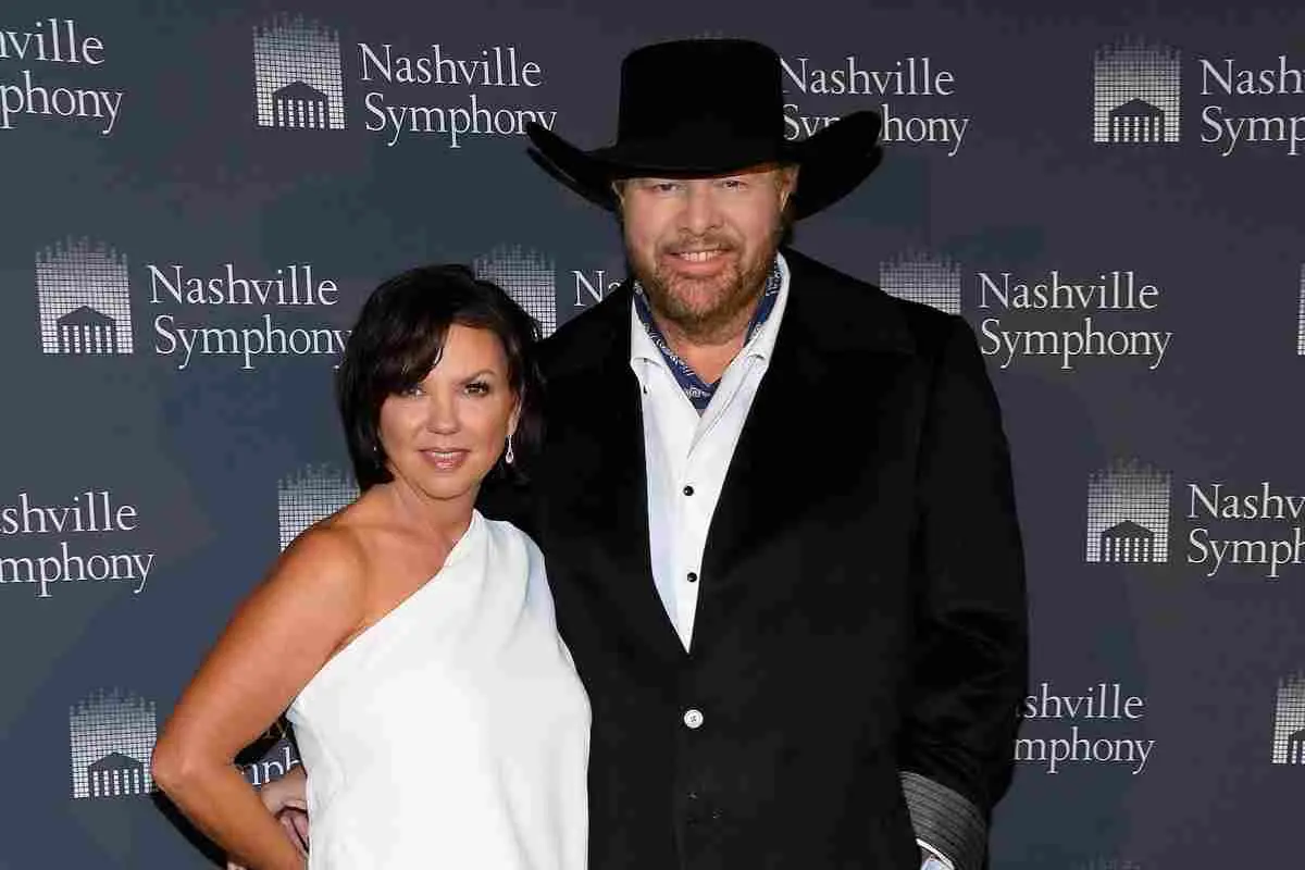 Toby Keith and Tricia Lucus posing together at a formal event.