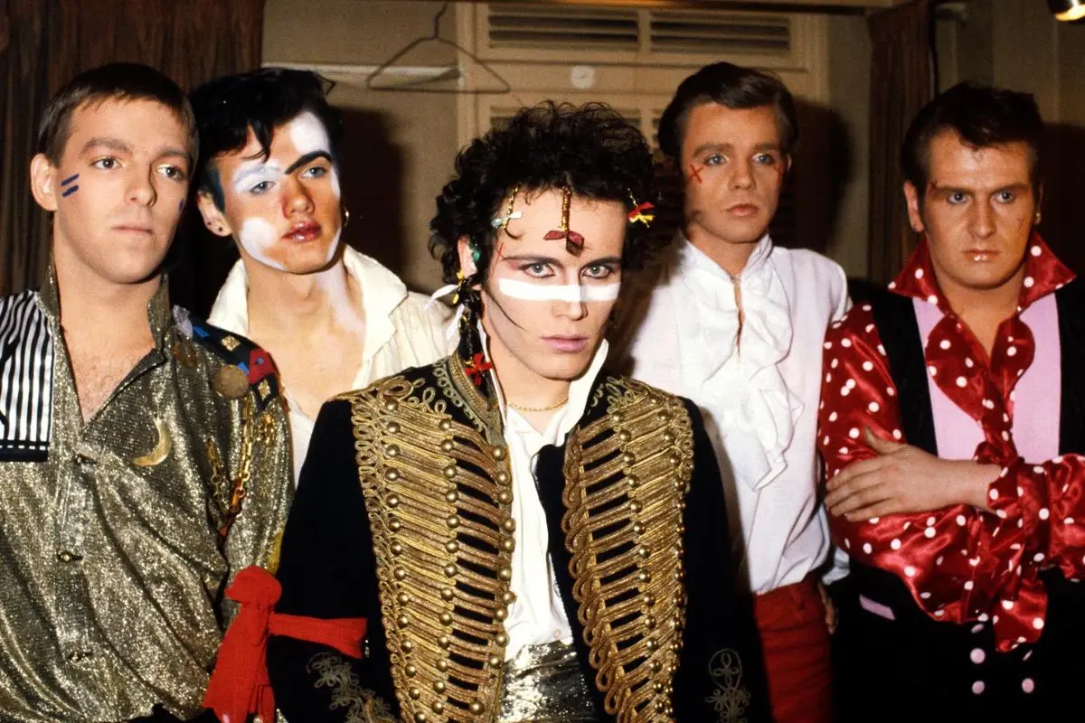 Adam and the Ants backstage wearing ornate pirate-style stage costumes.