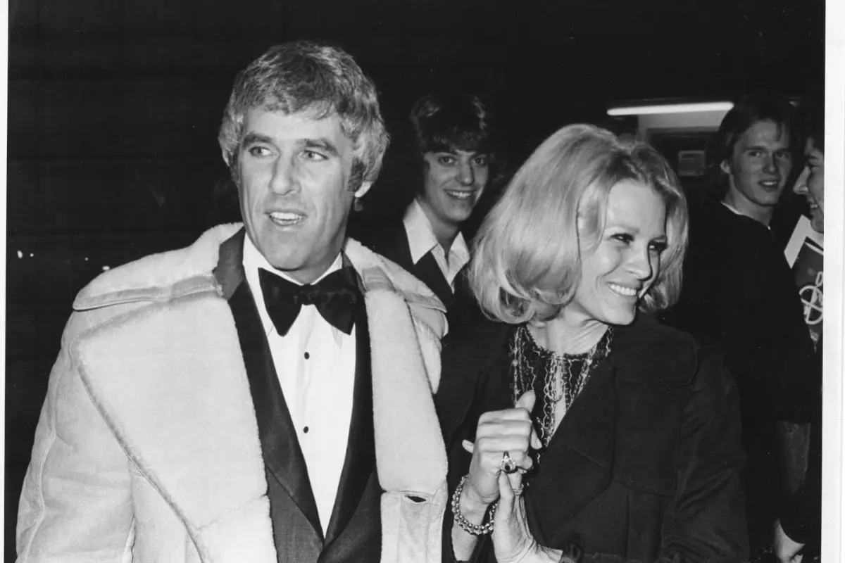 Burt Bacharach and Angie Dickinson walking together at night.