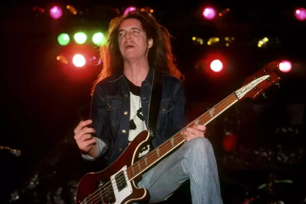 Cliff Burton playing a Rickenbacker bass guitar onstage.