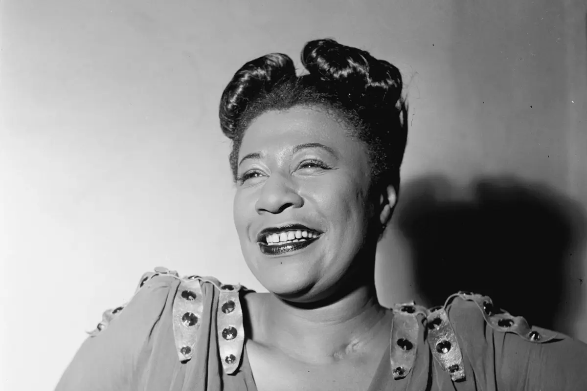 Ella Fitzgerald in a posed portrait, reflecting joy, confidence, and the enduring spirit of classic jazz performance.