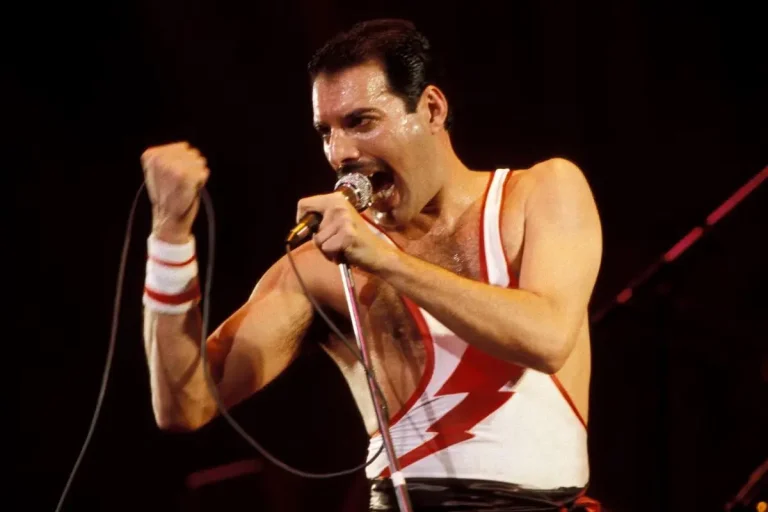 Freddie Mercury performs energetically onstage.