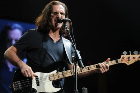 Geddy Lee of Rush performing live on stage.