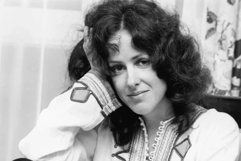 Grace Slick sitting with her head resting on her hand.