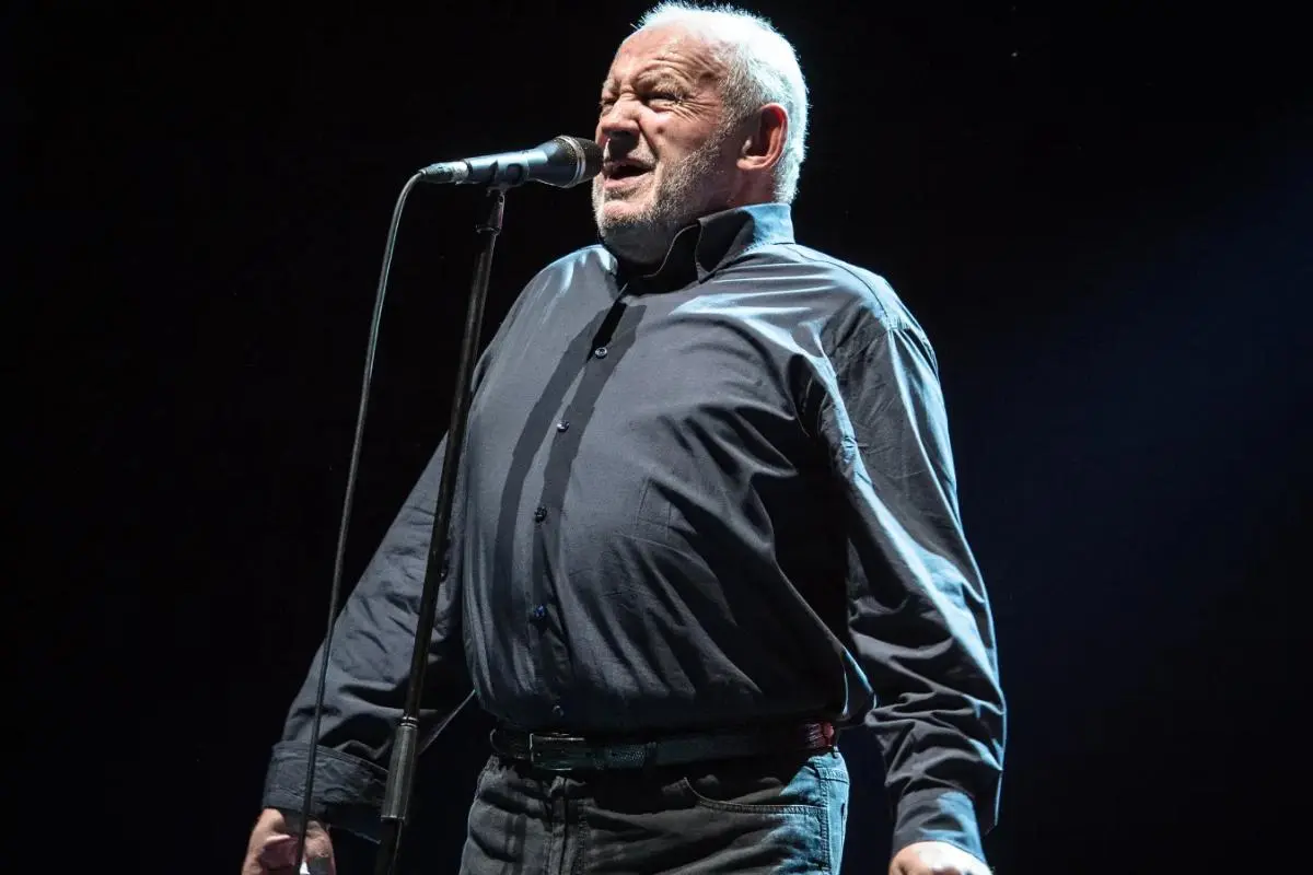 Joe Cocker singing onstage during a late-career live performance under stage lights.