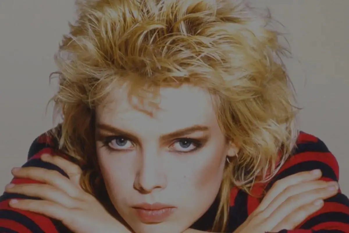 Kim Wilde with tousled blonde 1980s hair, resting her arms under her chin.