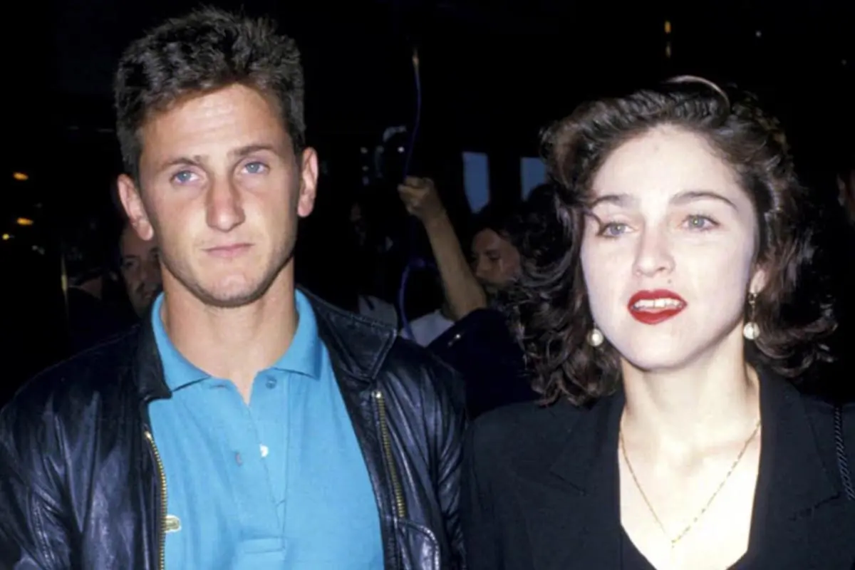 Sean Penn and Madonna stand close together at an event.