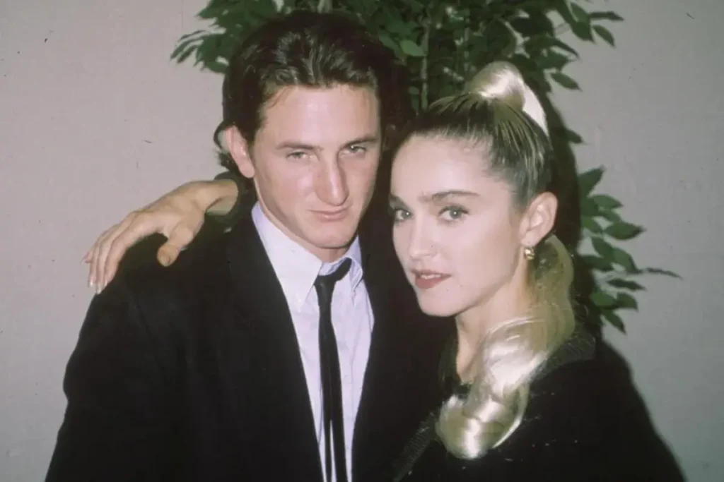 Madonna and Sean Penn pose for a photo, with her arm around him.