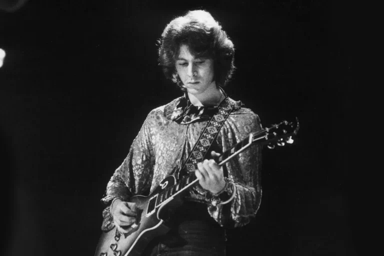 Mick Taylor playing guitar