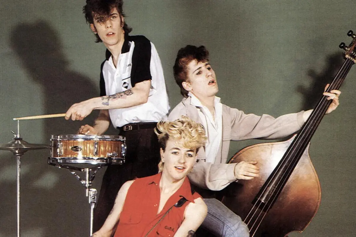 The Stray Cats posing with instruments in an early band photo.