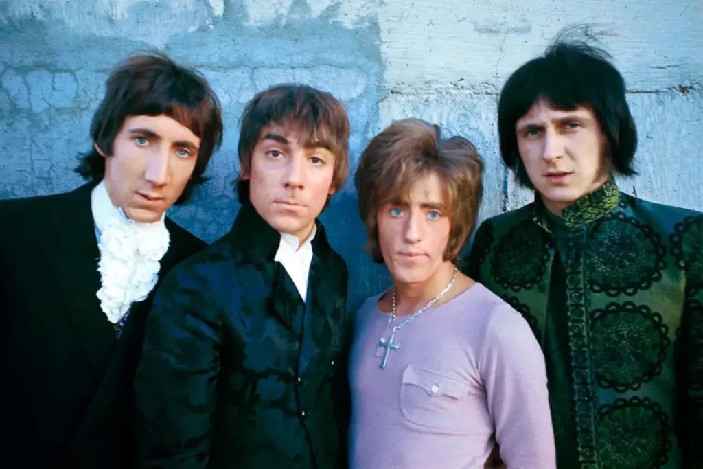 The Who in the Mid-60s: Mods, Mayhem, and the Birth of Heavy Rock Pete Townshend, John Entwistle, Roger Daltrey, and Keith Moon posing for a color portrait against a blue wall.