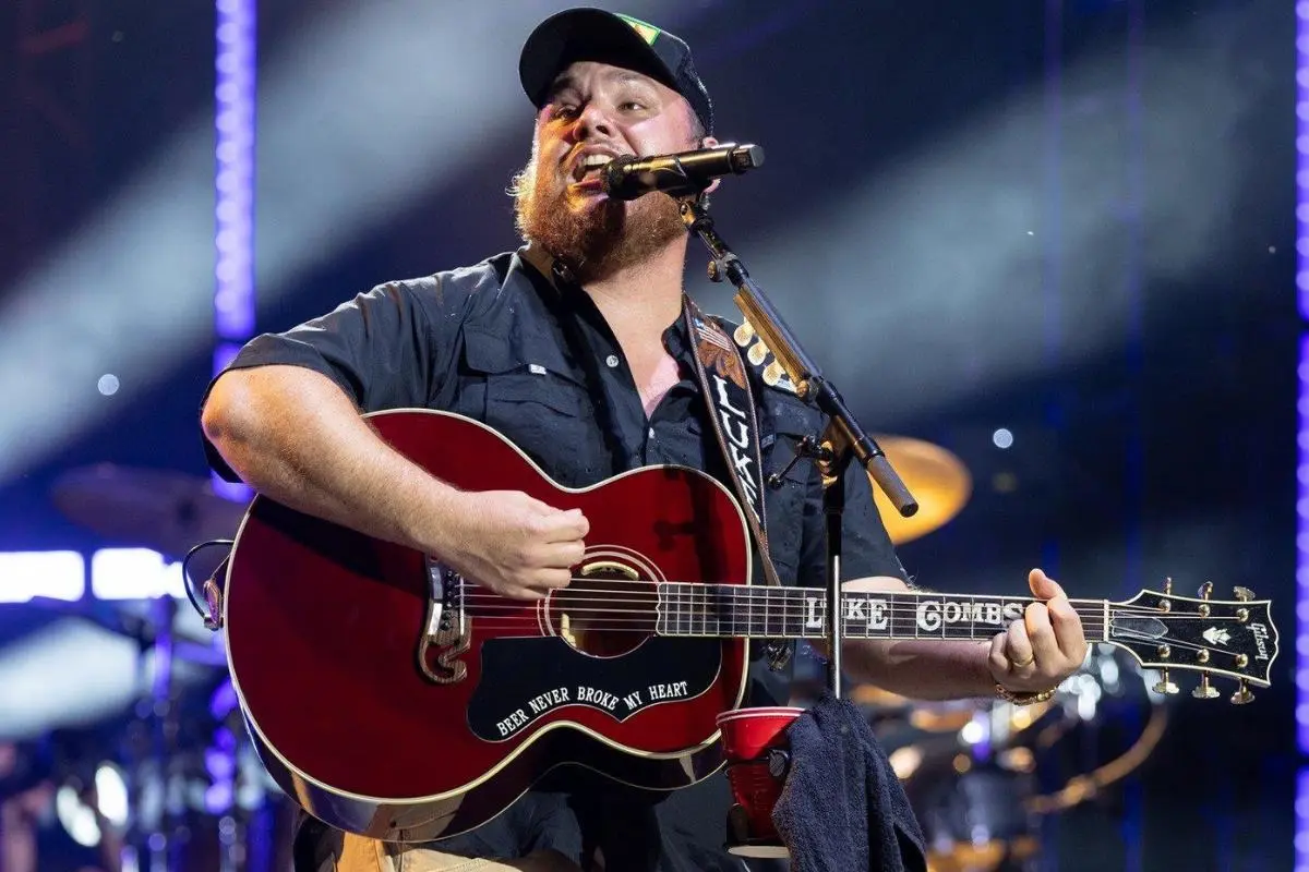 Tony Keith with a mullet and beard poses for a black-and-white portrait, wearing a jacket over a T-shirt.