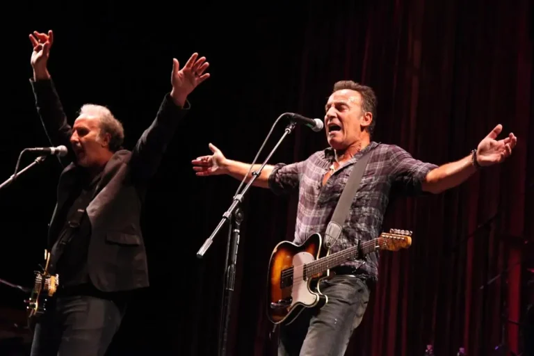 A Bruce Springsteen Statue in Freehold? What’s Real, What’s Hype, and Why It Matters Bruce Springsteen on stage with arms outstretched while singing into microphones.