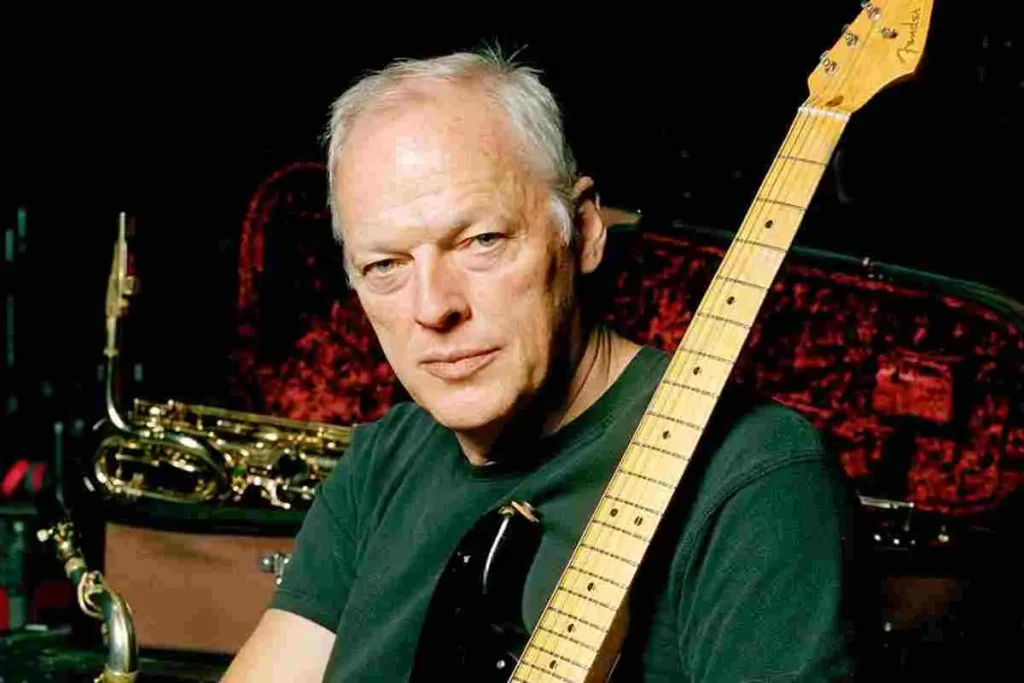 David Gilmour posing with an electric guitar in a studio setting.