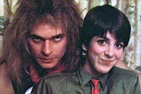 David Lee Roth and MTV VJ Martha Quinn posing closely together, mixing playful intensity and charm typical of 1980s rock and MTV culture.