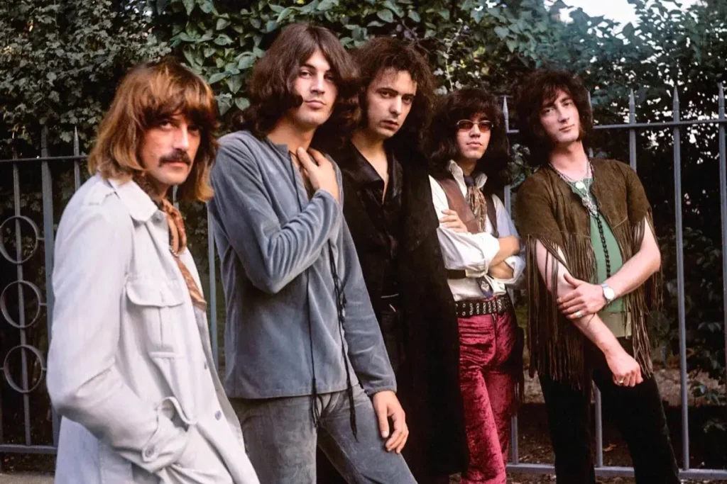 Deep Purple band standing together in flamboyant 1970s fashion, emphasizing the style and attitude of early hard rock culture.