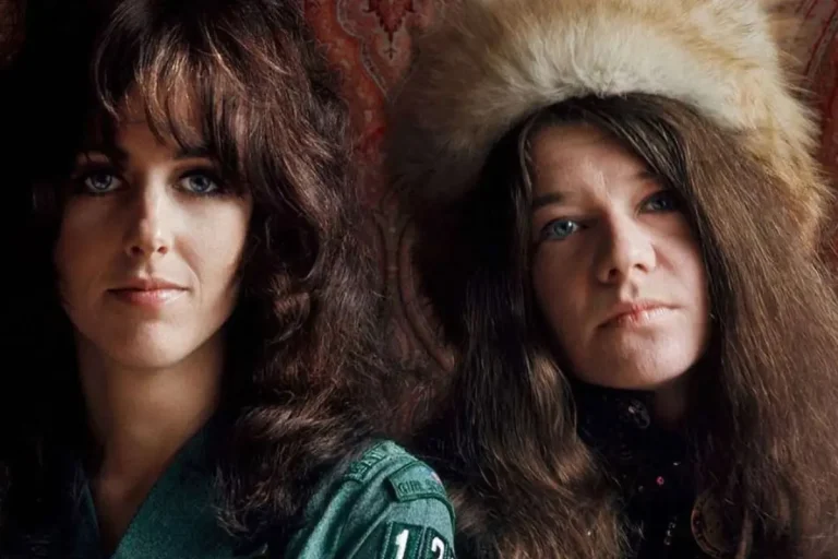 Grace Slick and Janis Joplin facing the camera, one wearing a fur hat, reflecting the distinctive style and expressive individuality of the late 1960s rock era.
